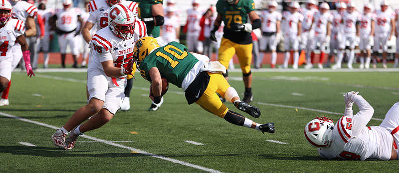 Brockport QB diving with the ball against Cortland