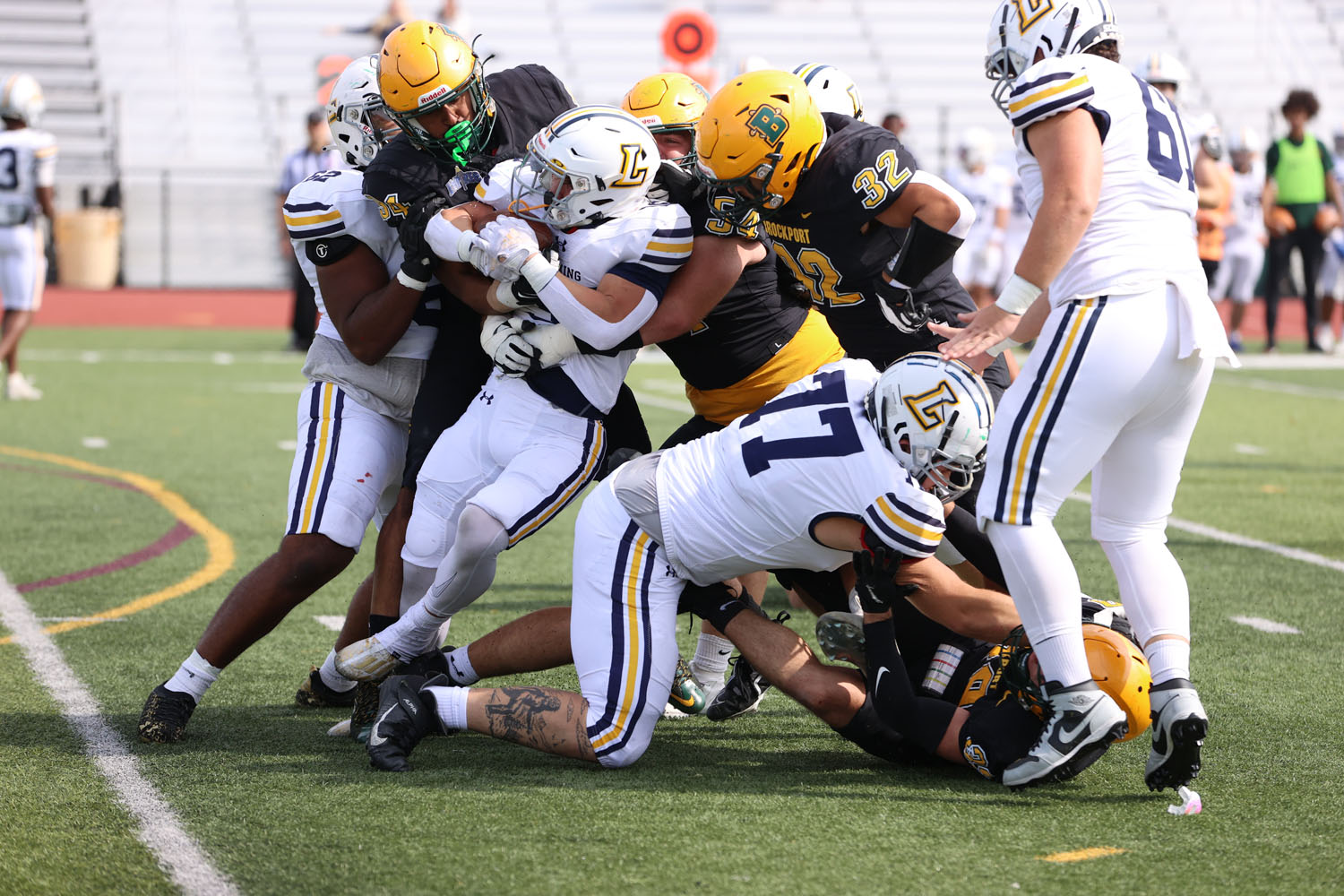 Brockport defense pushing the ball carrier back