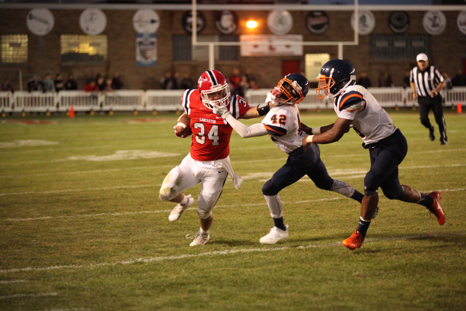 Andrew Hersey trying to break free with him and the defender holding each others facemask