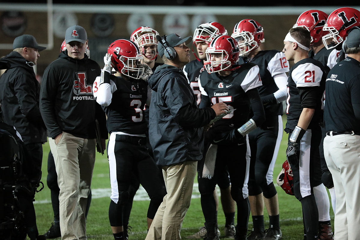 Coach Rupp in the huddle with his team