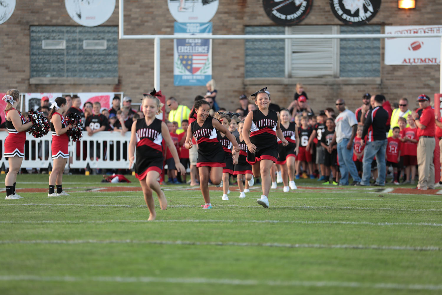 Lancaster Youth Cheerleaders running onto Foyle-Kling Field