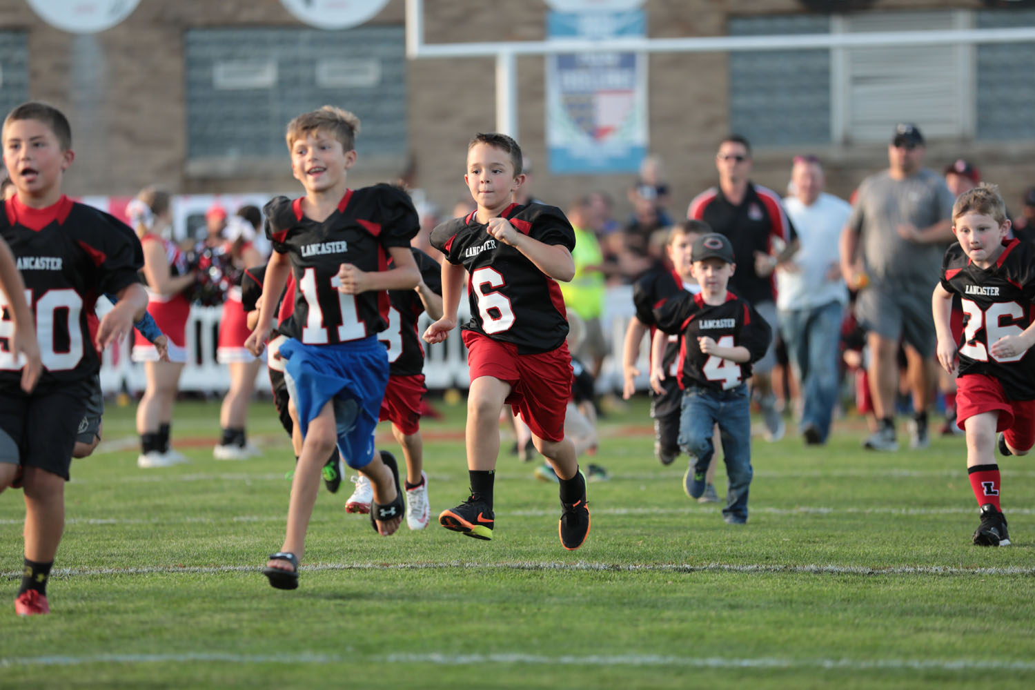 Lancaster Youth Football Players running onto Foyle-Kling Field