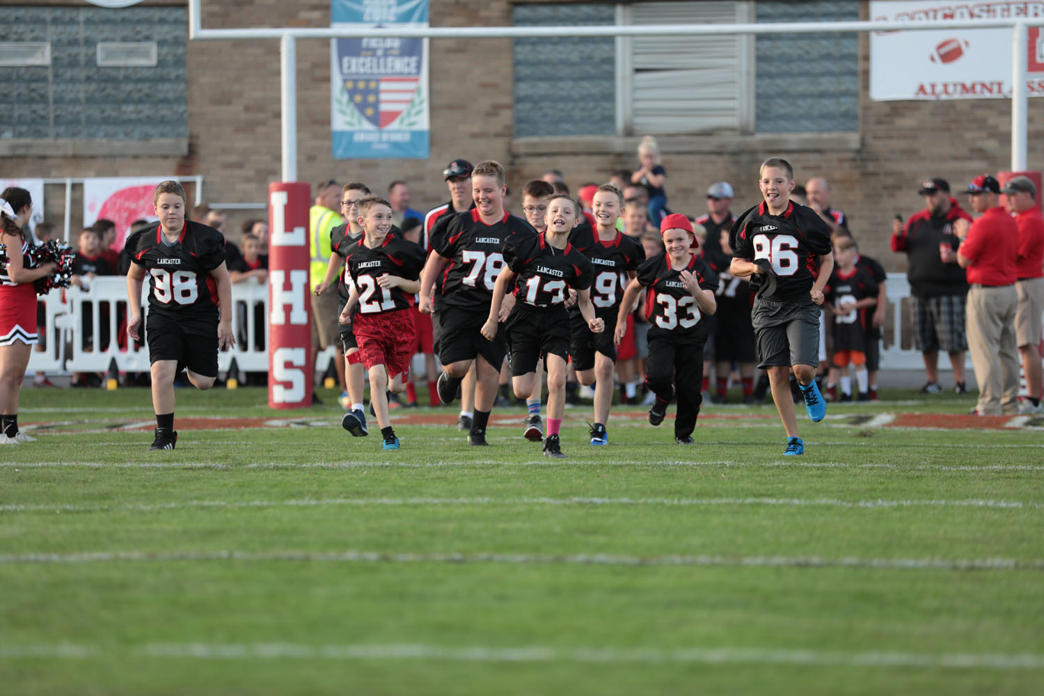 Lancaster Youth Football Players running onto Foyle-Kling Field