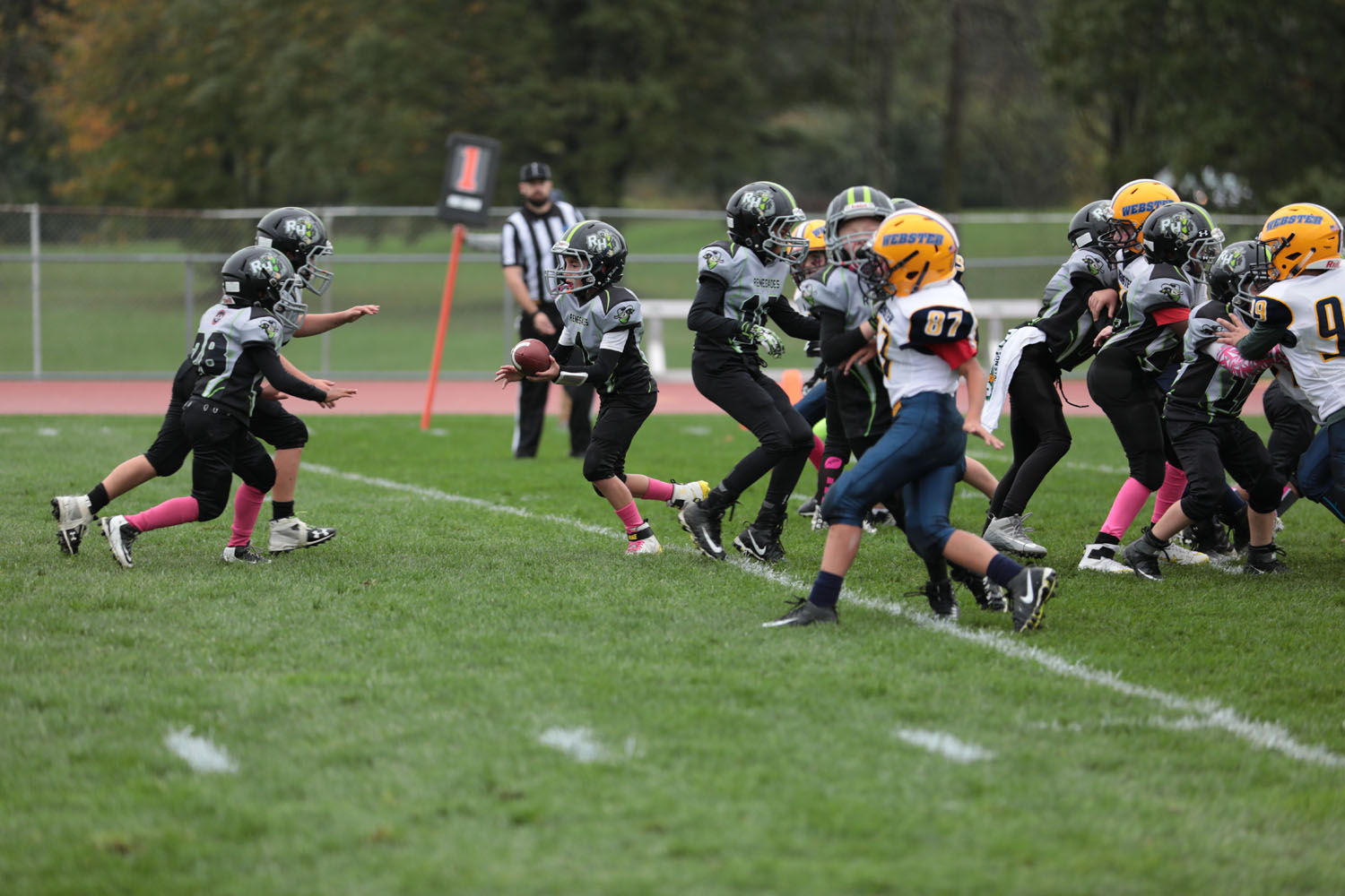 Brendan handing the ball off to his teammate