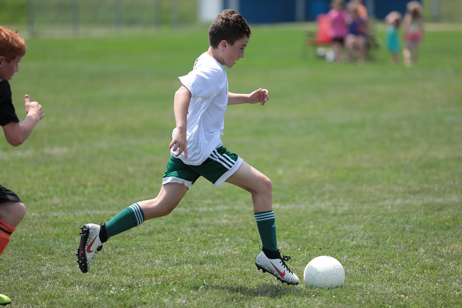 Brendan kicking the ball down the pitch