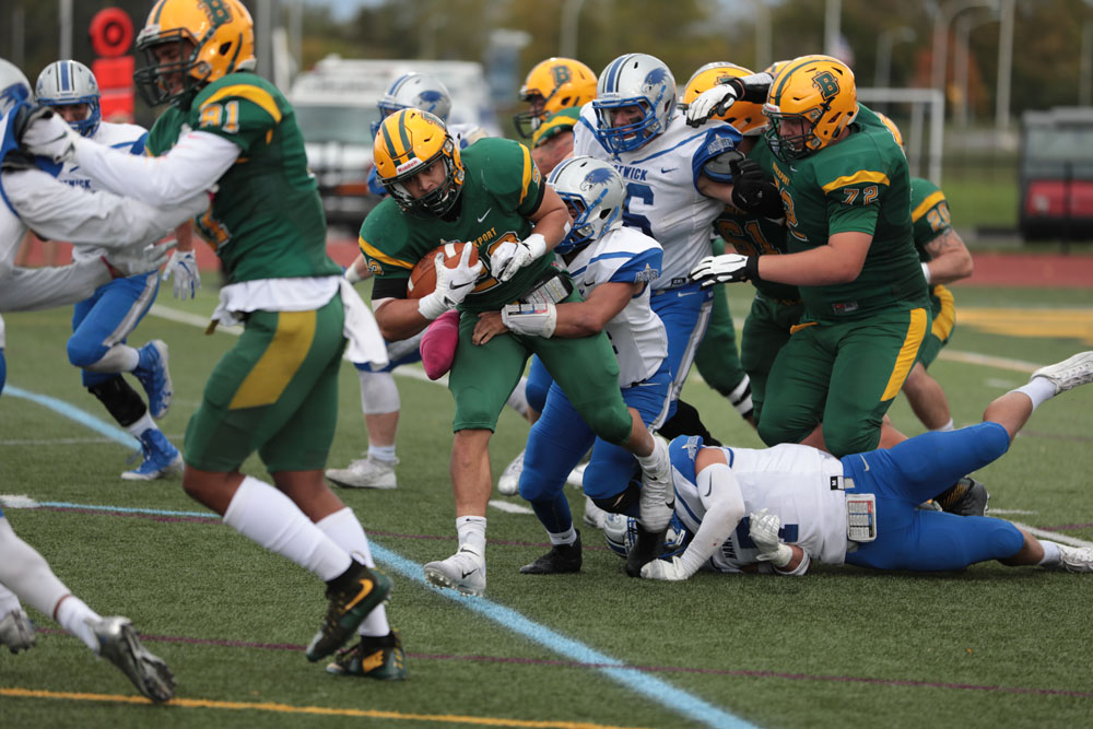 Justin Morrison shaking off defenders as he runs the ball