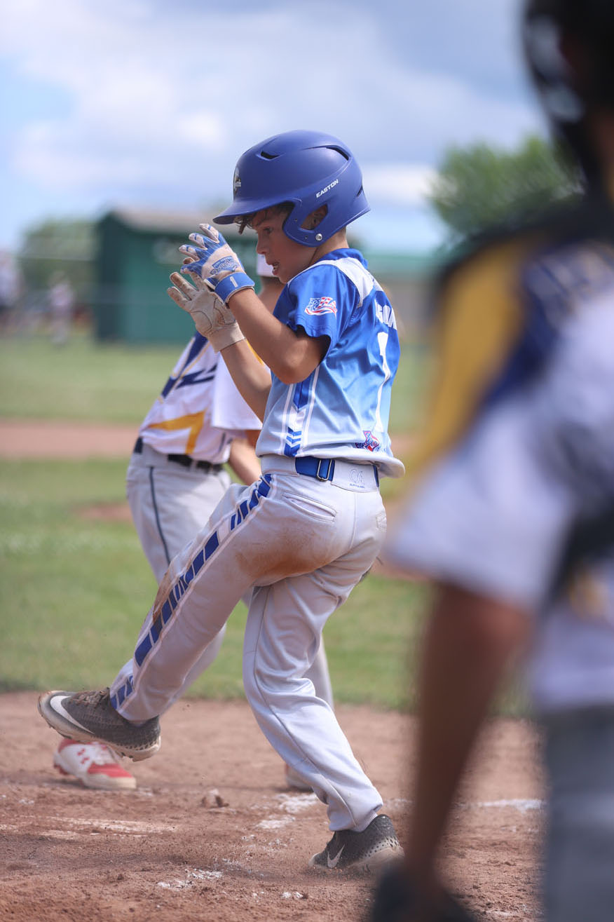 Evan reacting after he slides into home plate