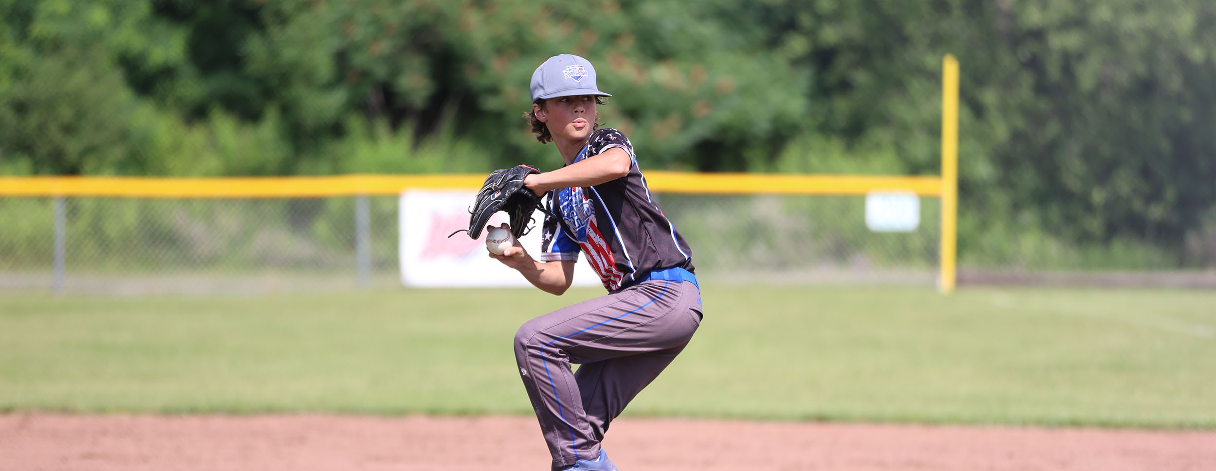 Evan winding up to throw a pitch