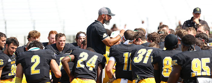 Coach Mangone talking to his team after a win against Framingham State