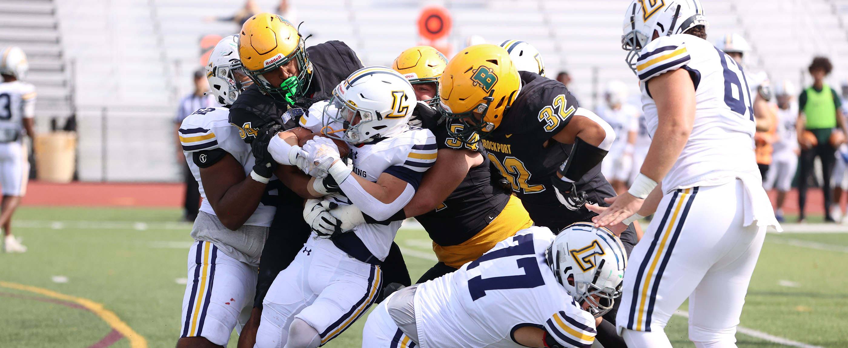 Taking down the ball carrier by the Brockport Defense