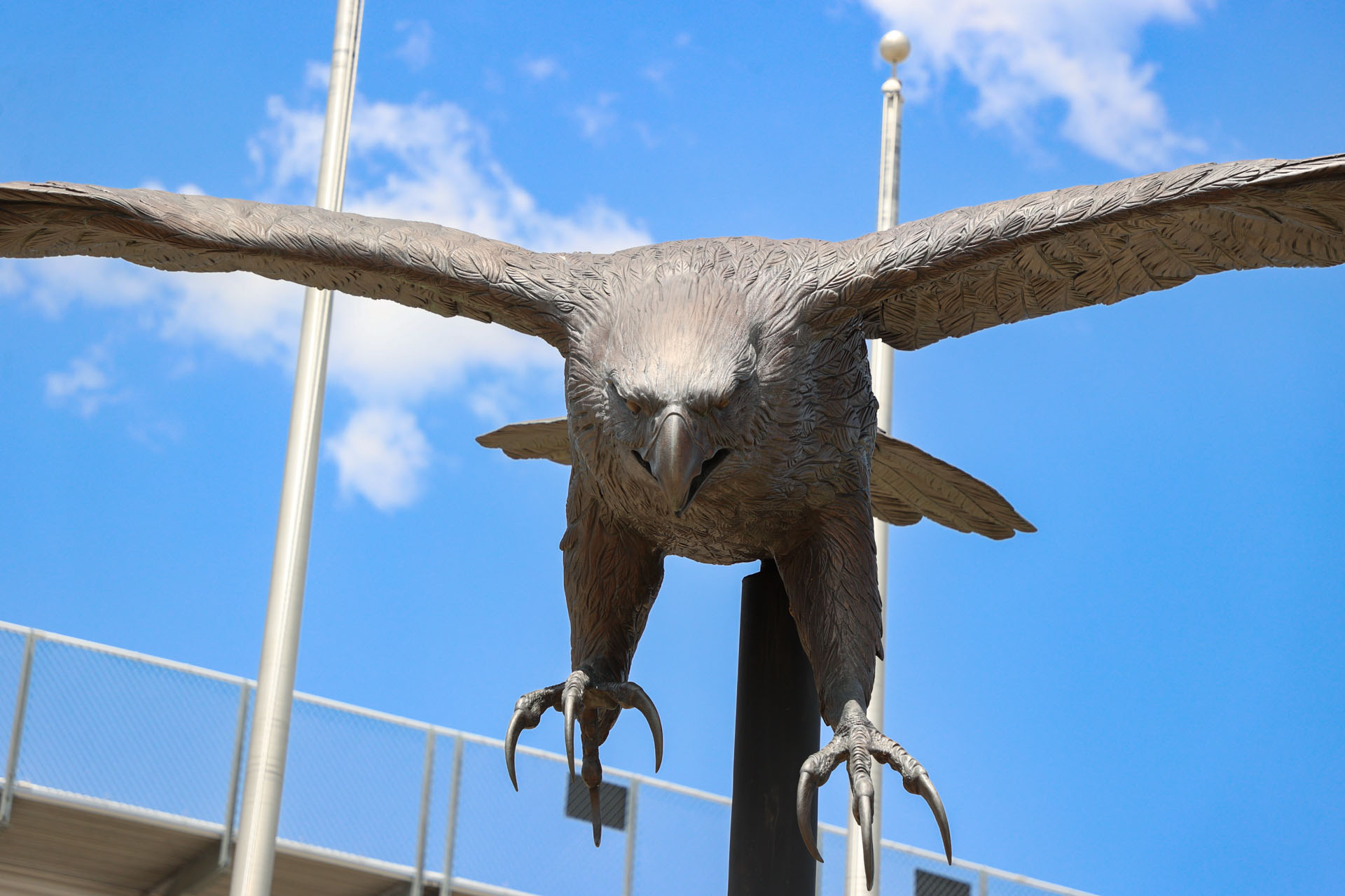 Falcon mascot in front of the stadium