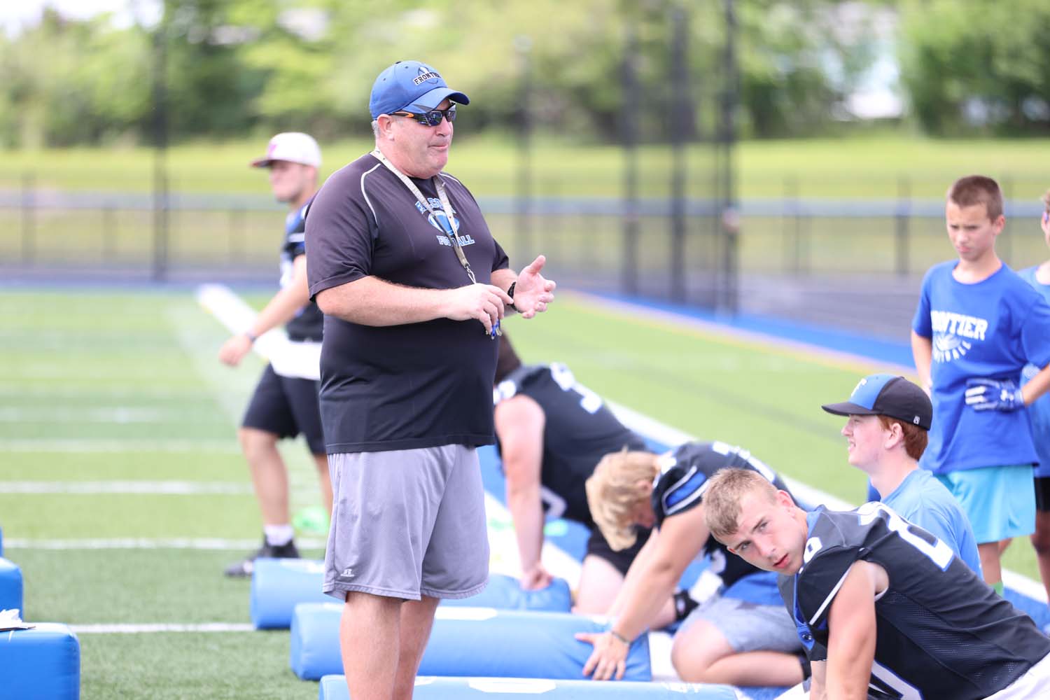 Coach Gray talking to the campers about a drill