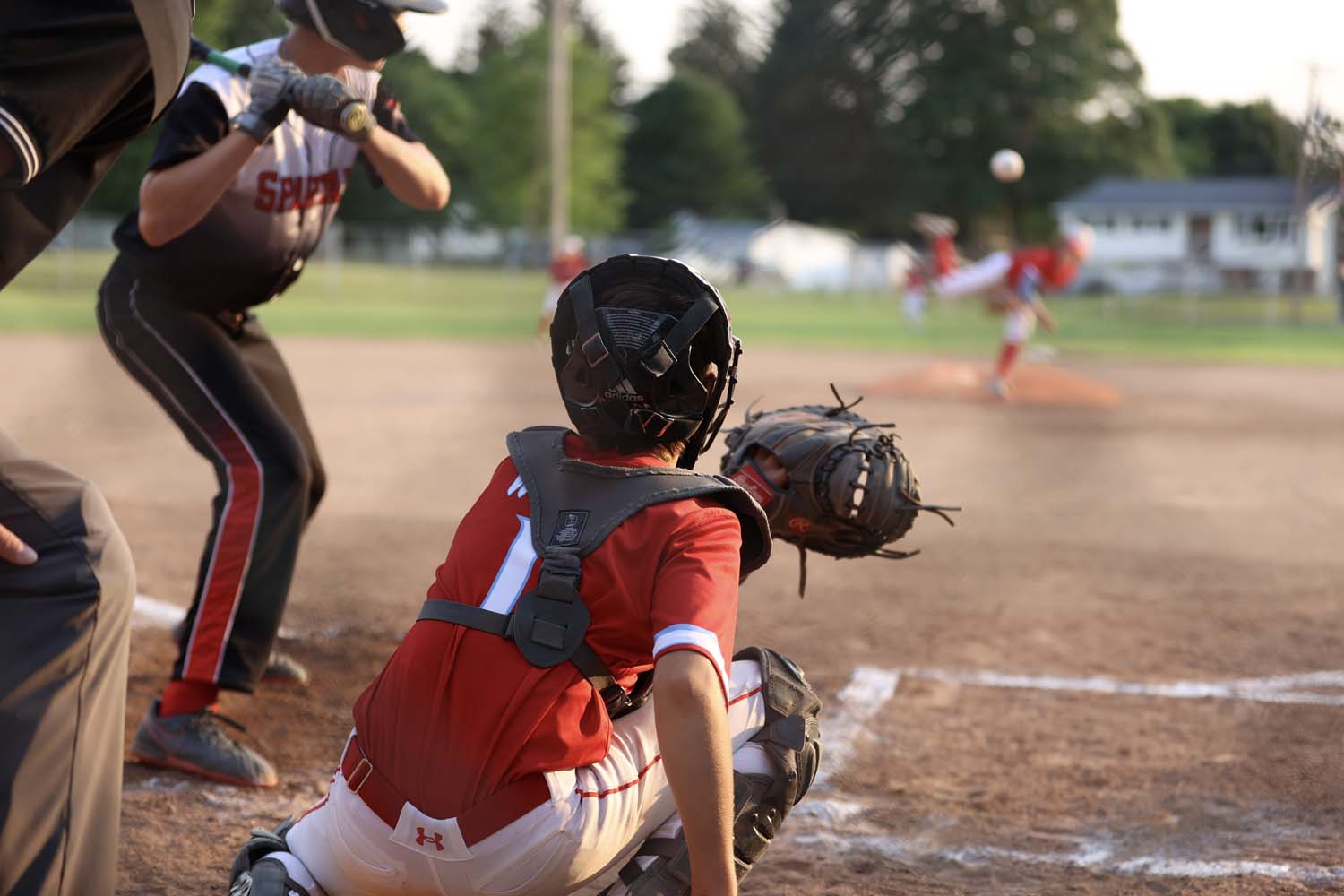 Parker playing catcher about to catch the ball