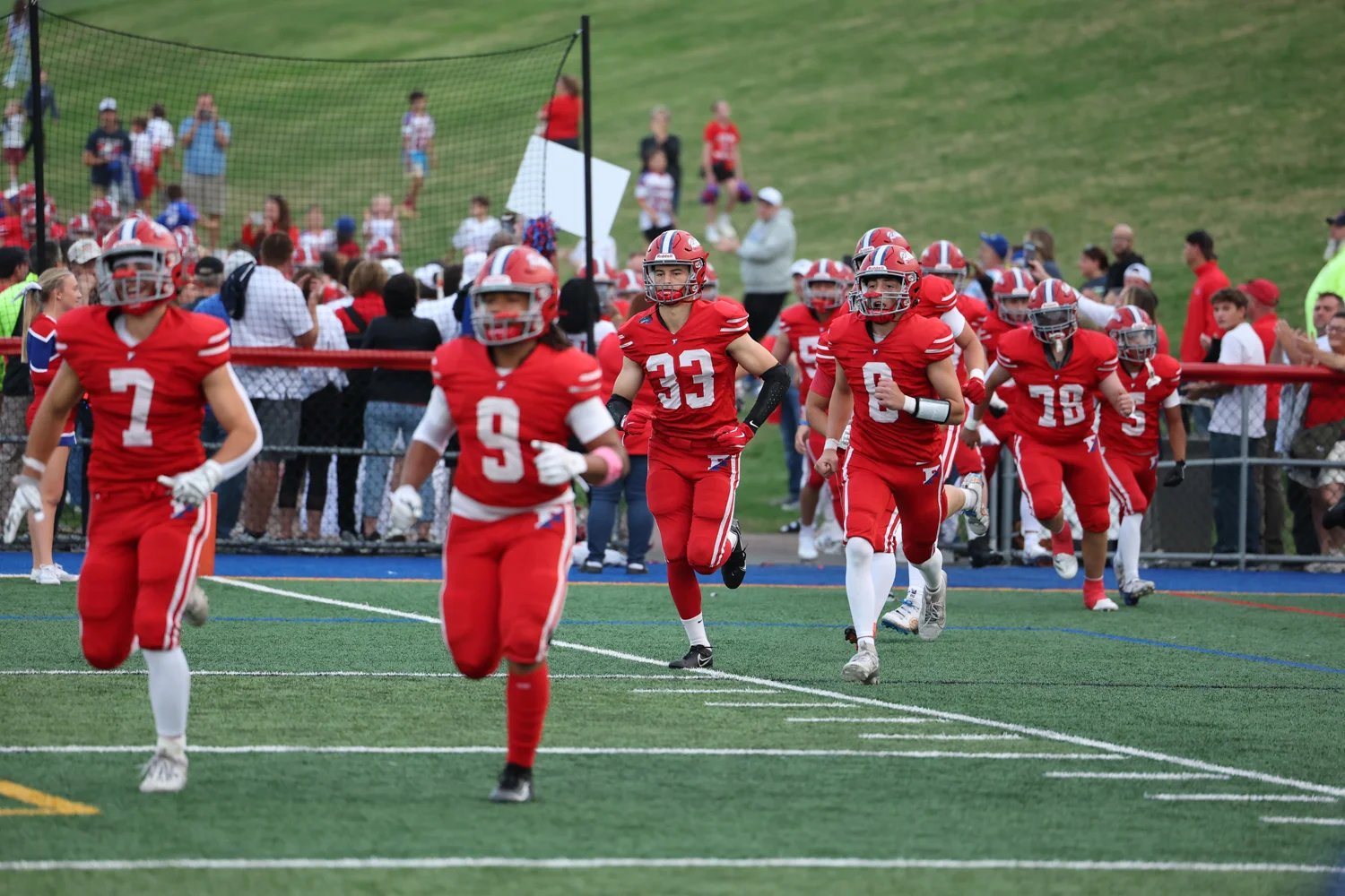The team running onto the field